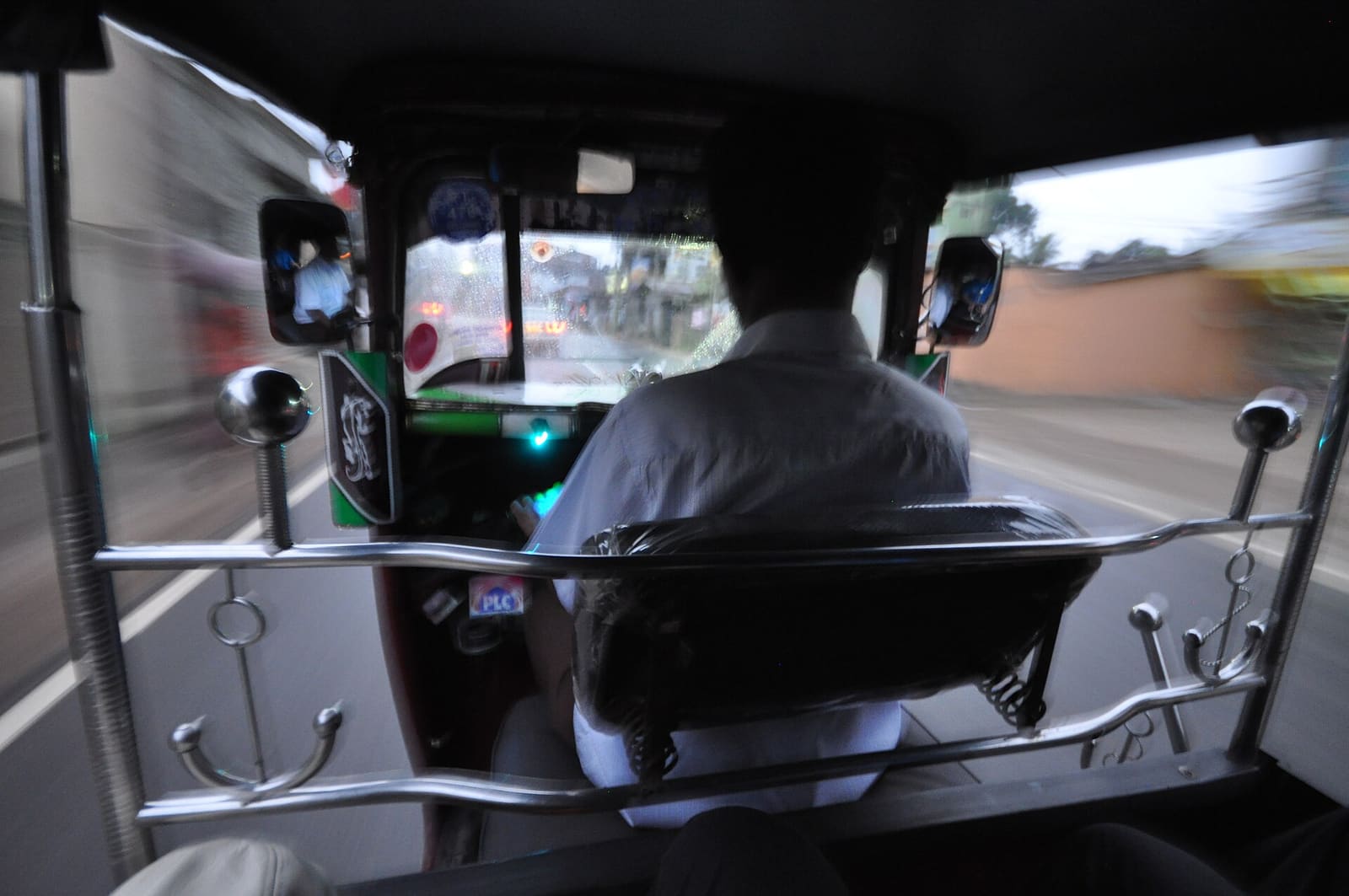 Private chauffeur car and a street taxi on a Sri Lankan road